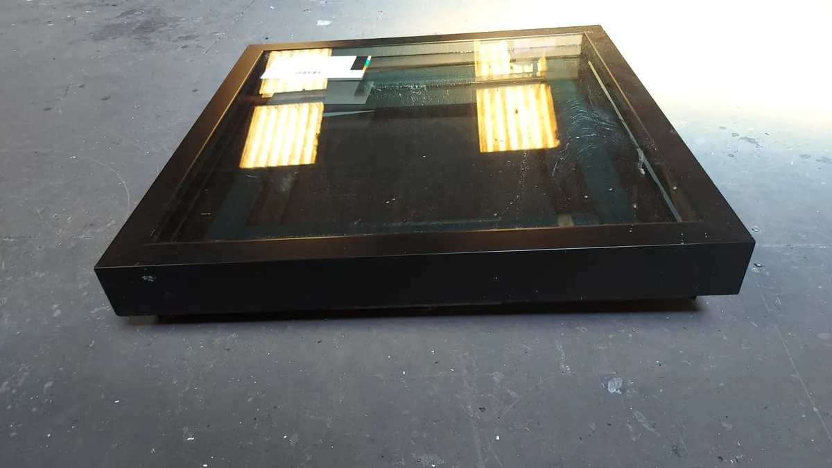 Black-framed flat glass rooflight assembled and glazed on the workshop floor before dispatch